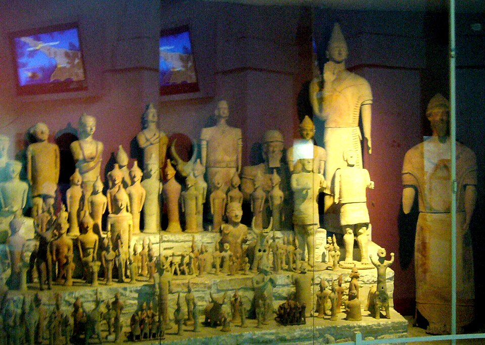 Rows of terracotta figurines from the sanctuary at Ayia Irini, in a glass case